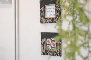 two framed photographs hanging on a wall at Beach Side Inn Shirahama in Shimoda
