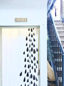 a door with a black and white curtain on it at Beach Side Inn Shirahama in Shimoda