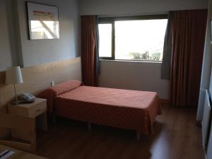 A bed or beds in a room at Hotel Escuela Madrid