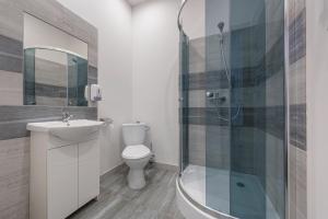 a bathroom with a toilet and a sink and a shower at 70s Hostel in Kraków