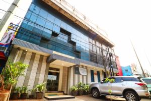 a car parked in front of a building at New Priok Indah Syariah Hotel in Jakarta