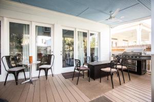 a porch with a table and chairs and a stove at Creole Cottage Uptown in New Orleans