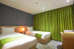מיטה או מיטות בחדר ב-Hotel Kuretakeso Insadong