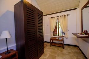 a room with a door and a table and a window at The Berrycove Bungalow in Kurunegala