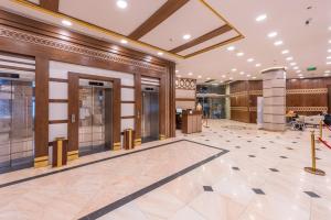 a lobby of a building with doors and a lobby at Grand Zowar Hotel in Medina