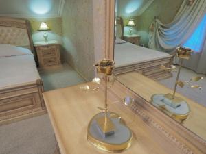 een slaapkamer met een bed en een grote spiegel bij Parus Park-hotel in Moskou