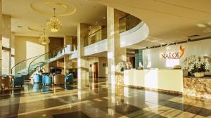 a lobby with a mall with escalators and chairs at The Nalod Da Nang in Danang +57 photos