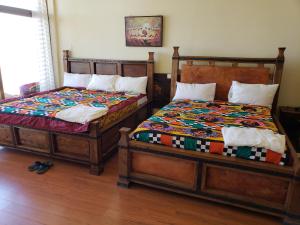 dos camas sentadas una al lado de la otra en una habitación en Top Twelve Hotel - Lalibela en Lalibela