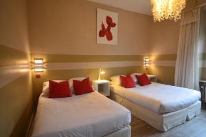 Letto o letti in una camera di Hôtel Vauban