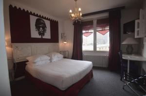 Letto o letti in una camera di Hôtel Vauban