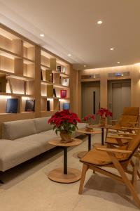 a living room with a couch and tables and chairs at Apartamentos Recoletos in Madrid