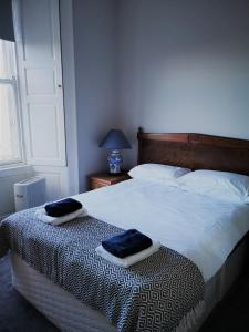 Un dormitorio con una cama con dos toallas encima. en Heritage City - Central York Place Apt, en Edimburgo