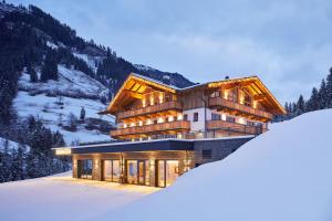 a house in the mountains in the snow at Berglodge Grossarl in Grossarl