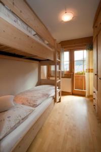 a bedroom with two bunk beds and a large window at Abelhof in Schladming