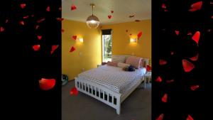 a bedroom with a bed with red hearts on the wall at Wendy's Holiday Home in Auckland