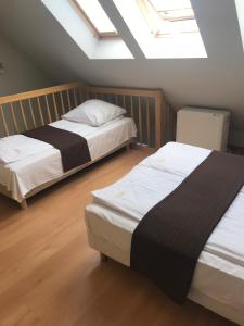 two beds in a room with skylights at Baltic Vip Apartamenty blisko morza in Rewal