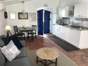 a living room with a couch and a table at Studio Colina in Tavira