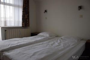 Ένα ή περισσότερα κρεβάτια σε δωμάτιο στο Residentie Caraibes, 9de verdieping