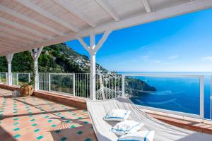 a porch with a hammock overlooking the ocean at Grand Hotel Tritone in Praiano