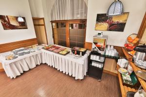 a room with two tables with food on it at Attic Hotel in Prague