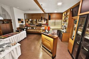 a large kitchen with tables in a restaurant at Attic Hotel in Prague