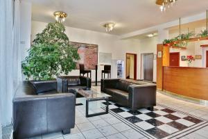 a lobby with leather couches and a table at Attic Hotel in Prague