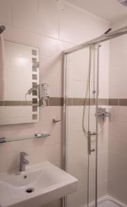 a bathroom with a sink and a shower at Pension Haus Marga in Bad Kissingen
