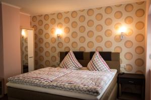 a bedroom with a bed with two pillows on it at Pension Haus Marga in Bad Kissingen