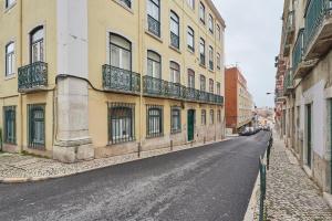 an empty street in a city with buildings at Casa Eclea Lisbon Principe Real in Lisbon
