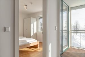 a room with a bed and a window at Appartements Ramsau am Dachstein by Schladmingurlaub in Ramsau am Dachstein