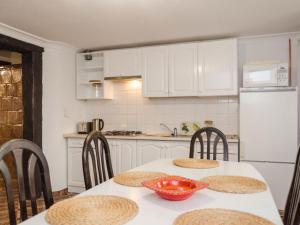 a kitchen with a table with chairs and a refrigerator at Apartment south in Darłowo