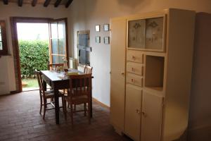 a dining room with a table and a cabinet at Casa di Romano, Al Tramonto in Marcialla