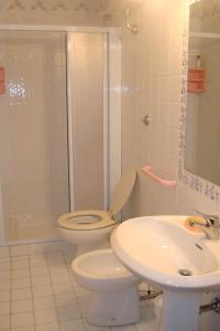 a bathroom with a toilet and a sink and a shower at Casa di Romano, Al Tramonto in Marcialla