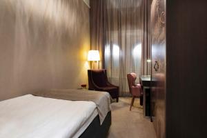 Postel nebo postele na pokoji v ubytování Elite Plaza Hotel