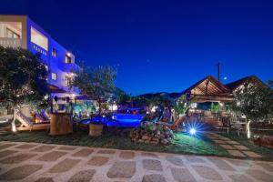 a resort with a swimming pool at night at Villa Gereoudis Apartments with Sea View & Pool in Kolymvari