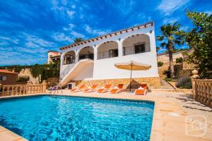a villa with a swimming pool and a house at Villa Bellavista by Abahana Villas in Benissa
