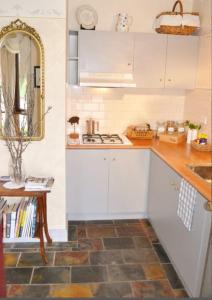 a kitchen with white cabinets and a counter top at Bindley House B&B Cottage in Kilmore