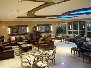 a large living room with couches and tables at Manazilna Apartments Riyadh منازلنا للشقق المفروشة in Riyadh