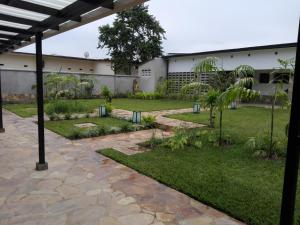 a courtyard of a building with a garden at Urban Lodge in Bujumbura
