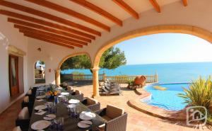 a dining room with a view of the ocean at Villa Gaviota by Abahana Villas in Moraira