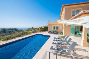 a villa with a swimming pool and views of the ocean at Villa Las Flores by Abahana Villas in Benissa