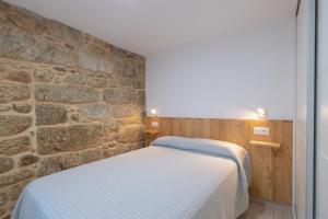 Postel nebo postele na pokoji v ubytování Apartamentos Mar de Fondo Muxia