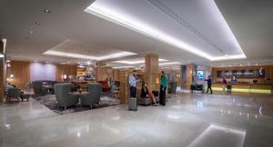 two people standing in a lobby of a hotel at Clayton Hotel Burlington Road in Dublin