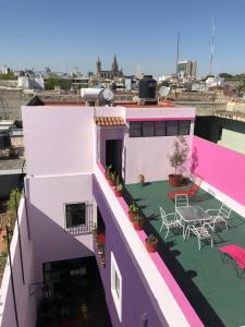 a building with a balcony with a table and chairs at Olga Querida B&B Hostal in Guadalajara