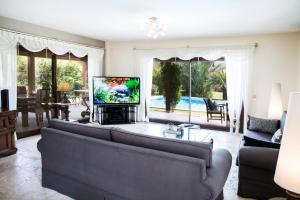 A television and/or entertainment centre at Villa Mertcan by Important Group Travel BD439