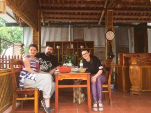a group of three people sitting at a table at Tam Coc mountain bungalow in Ninh Binh