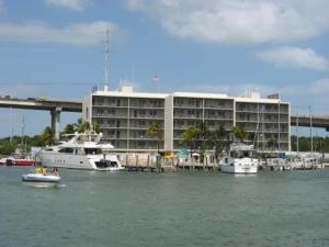 two boats in the water in front of a building at Anchorage Resort in Key Largo
