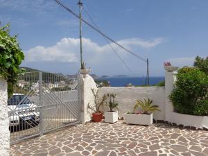 a white gate with potted plants on a white wall at Villa Flavia - Adults Only in Ponza