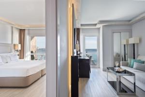 a hotel room with a large bed and a large mirror at Melia Alicante in Alicante