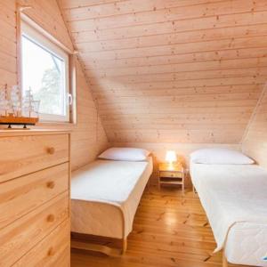 En eller flere senge i et værelse på Błękitne domki przy morzu